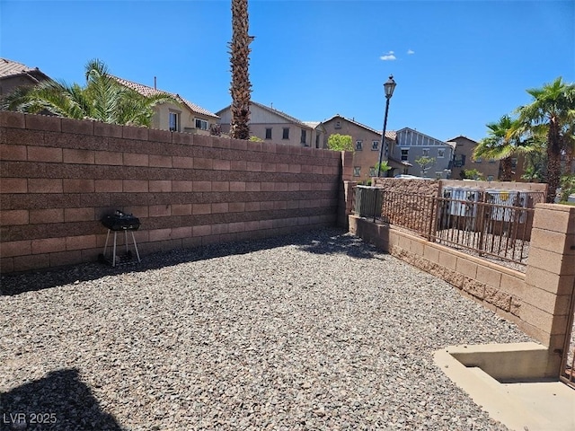 view of yard featuring fence and a residential view