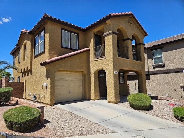 mediterranean / spanish-style house with a garage, stucco siding, a tile roof, and a balcony