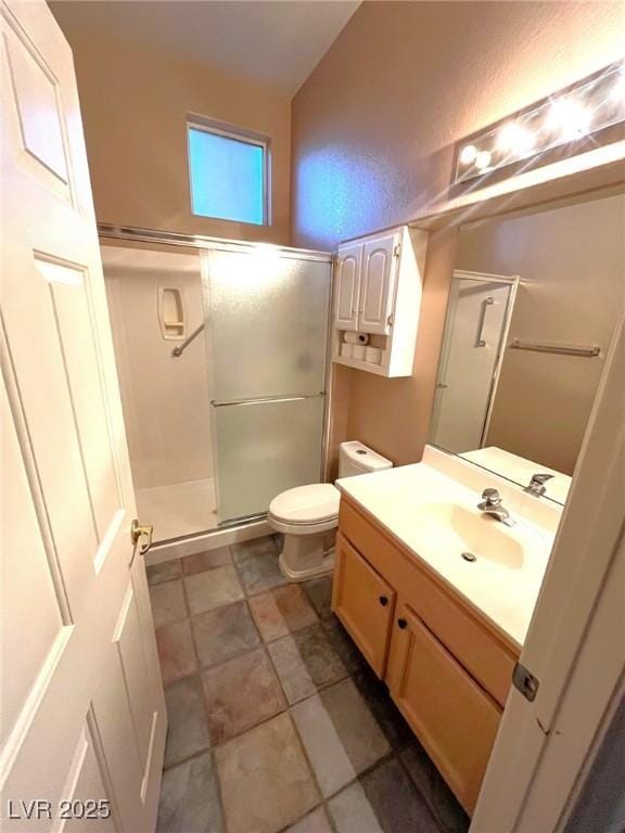 10717 Grand Cypress Ave, Las Vegas, NV 89134 - bathroom with toilet, vaulted ceiling, a shower stall, and vanity