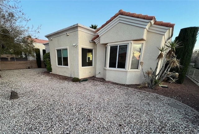 10717 Grand Cypress Ave, Las Vegas, NV 89134 - back of property with stucco siding, fence, and a tile roof
