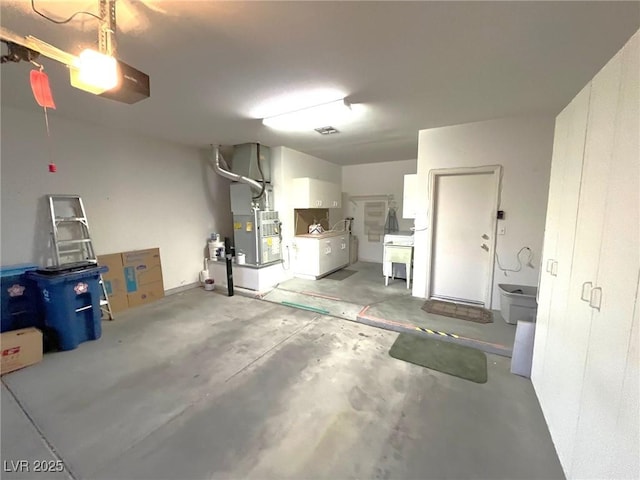 10717 Grand Cypress Ave, Las Vegas, NV 89134 - garage with washer / clothes dryer and heating unit