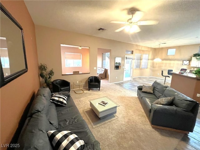 10717 Grand Cypress Ave, Las Vegas, NV 89134 - carpeted living area with a ceiling fan, a textured ceiling, and visible vents