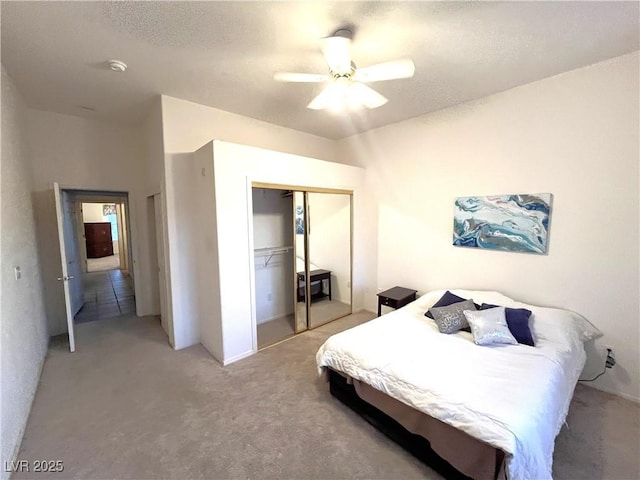 10717 Grand Cypress Ave, Las Vegas, NV 89134 - bedroom with a ceiling fan, light carpet, and a closet
