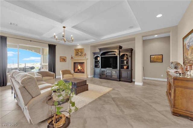 living area featuring visible vents, baseboards, a warm lit fireplace, an inviting chandelier, and coffered ceiling