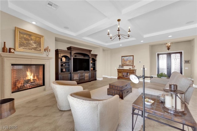 living area featuring visible vents, a chandelier, recessed lighting, a lit fireplace, and coffered ceiling