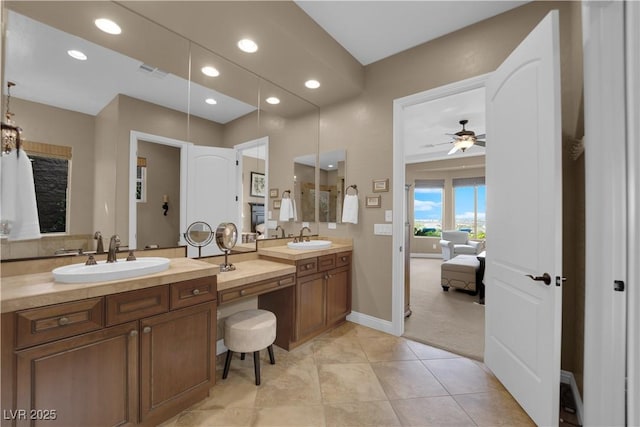 ensuite bathroom featuring recessed lighting, ceiling fan, visible vents, and a sink
