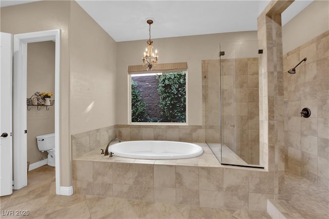 bathroom featuring a notable chandelier, tile patterned flooring, toilet, a shower stall, and a garden tub