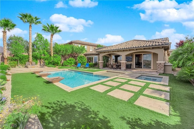 pool with an in ground hot tub and a patio area