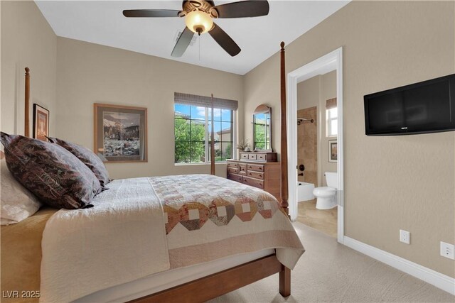 bedroom featuring baseboards, ceiling fan, ensuite bath, and light colored carpet