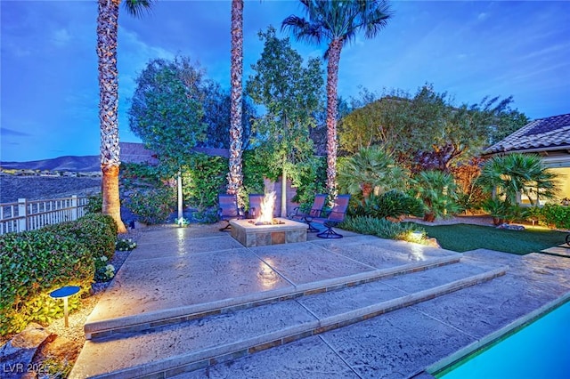 exterior space featuring a patio, fence, and a fire pit