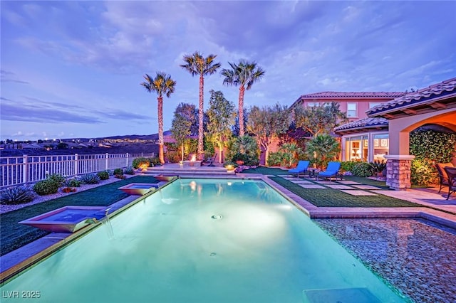 view of swimming pool featuring a fenced in pool, a fenced backyard, a jacuzzi, and a patio