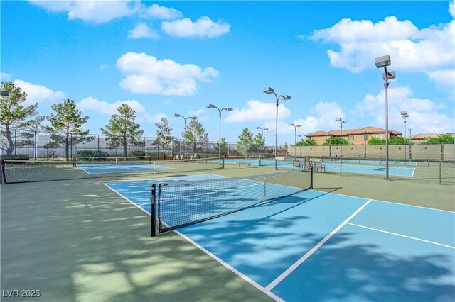 view of tennis court with fence