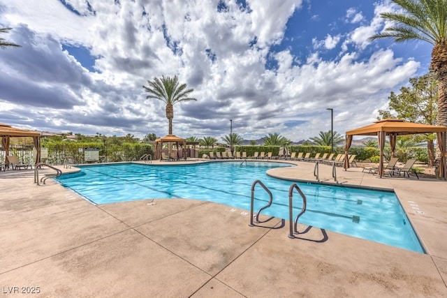 pool featuring a gazebo, fence, and a patio area