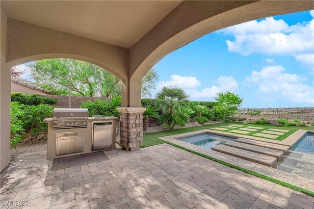 view of patio / terrace featuring a fenced backyard, area for grilling, a fenced in pool, exterior kitchen, and a hot tub