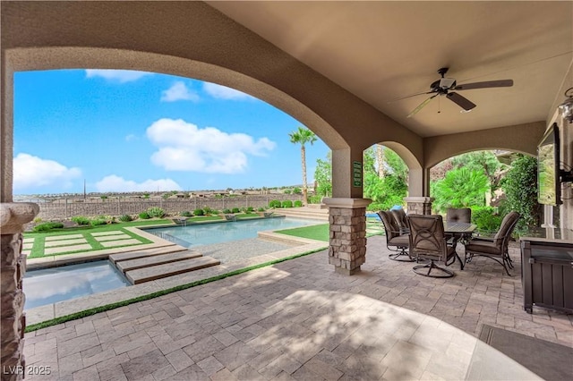 view of patio featuring a fenced backyard, outdoor dining area, a fenced in pool, and ceiling fan
