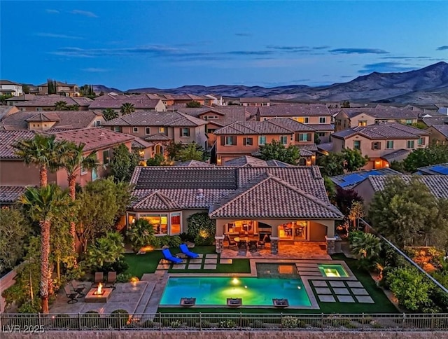 rear view of house featuring a residential view, a patio, a fire pit, and fence private yard