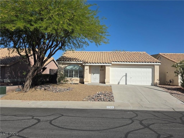 734 Rusty Spur Dr, Henderson, NV 89014 - mediterranean / spanish-style house featuring an attached garage, stucco siding, driveway, and a tile roof