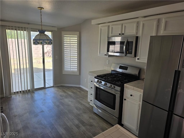 734 Rusty Spur Dr, Henderson, NV 89014 - kitchen with plenty of natural light, baseboards, tile counters, and stainless steel appliances