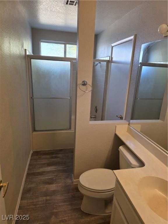 734 Rusty Spur Dr, Henderson, NV 89014 - full bathroom featuring vanity, toilet, baseboards, wood finished floors, and a shower with door