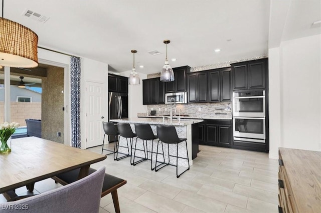 3136 Mossfield Ave, Henderson, NV 89052 - kitchen featuring stainless steel appliances, dark cabinets, backsplash, ceiling fan, and recessed lighting