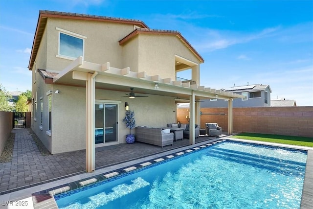 3136 Mossfield Ave, Henderson, NV 89052 - rear view of house featuring stucco siding, a ceiling fan, outdoor lounge area, a fenced backyard, and a patio area