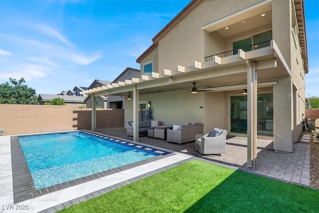 3136 Mossfield Ave, Henderson, NV 89052 - rear view of house featuring stucco siding, a balcony, ceiling fan, an outdoor living space, and a patio area