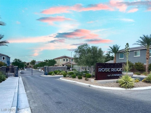 3136 Mossfield Ave, Henderson, NV 89052 - view of asphalt road featuring a gate, sidewalks, curbs, and a gated entry