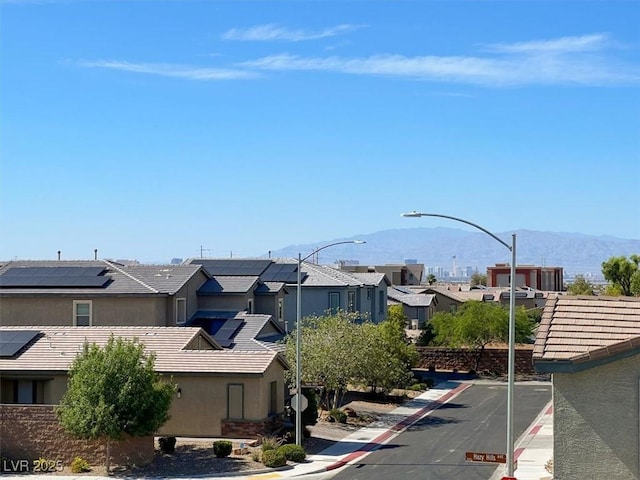 3136 Mossfield Ave, Henderson, NV 89052 - view of asphalt street with a mountain view, curbs, a residential view, sidewalks, and street lights