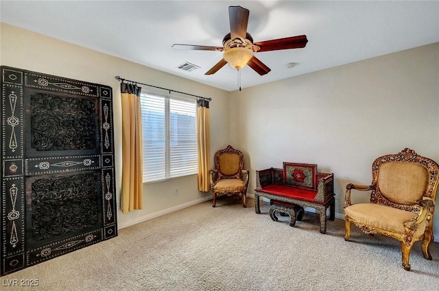 sitting room with visible vents, a ceiling fan, carpet, and baseboards