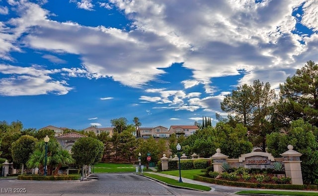 1353 Volturno Way, Henderson, NV 89052 - view of asphalt street featuring traffic signs, sidewalks, street lights, curbs, and a gated entry