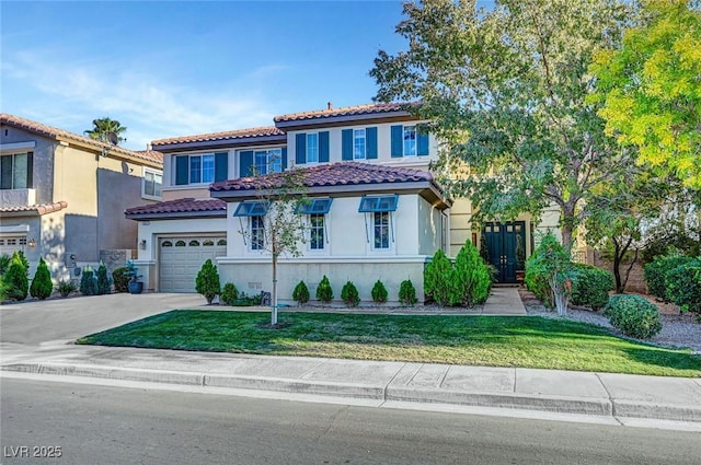 mediterranean / spanish-style house featuring a tiled roof, driveway, a front yard, a garage, and stucco siding