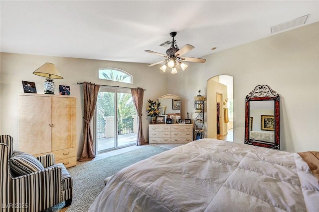 bedroom featuring carpet floors, access to outside, arched walkways, and visible vents
