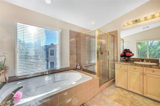 full bath with tile patterned floors, a shower stall, a garden tub, and vanity