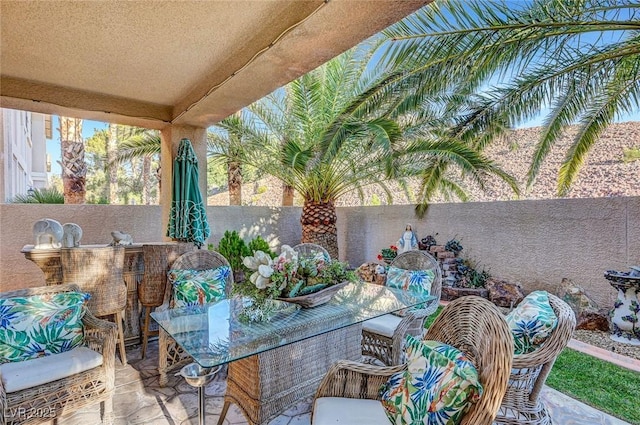 view of patio with outdoor dining space and a fenced backyard