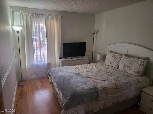 3164 Elmrock Pl, Las Vegas, NV 89121 - bedroom with baseboards, a textured ceiling, and wood finished floors