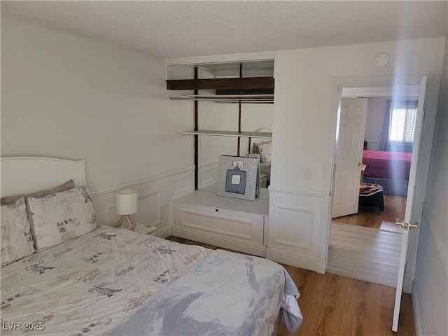 3164 Elmrock Pl, Las Vegas, NV 89121 - bedroom with a textured ceiling and wood finished floors