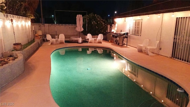 3164 Elmrock Pl, Las Vegas, NV 89121 - pool at twilight featuring a patio, fence, and a fenced in pool