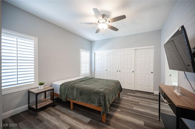 bedroom featuring baseboards, a ceiling fan, a closet, and wood finished floors