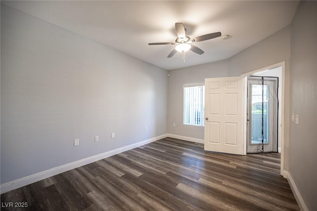unfurnished bedroom featuring baseboards, ceiling fan, and dark wood-type flooring