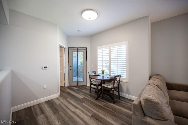 dining area with baseboards and wood finished floors
