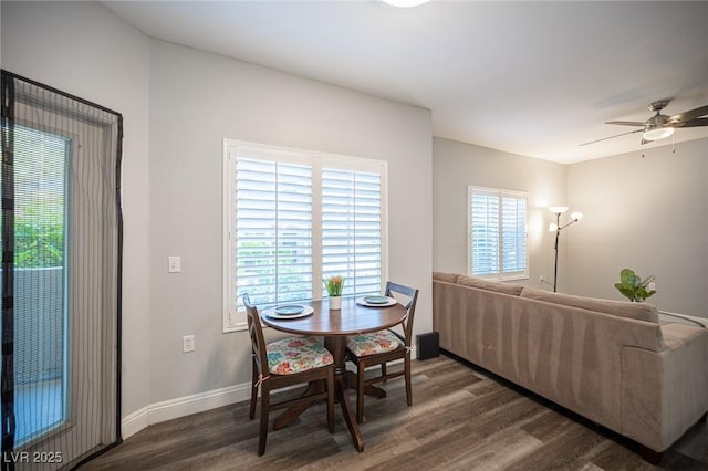 dining room featuring a ceiling fan, baseboards, and wood finished floors