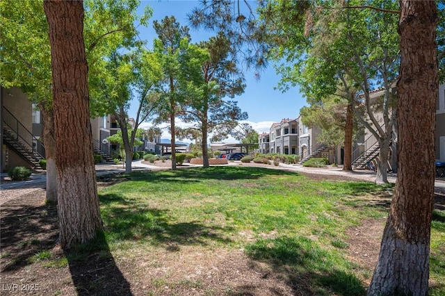 view of yard featuring a residential view and stairway