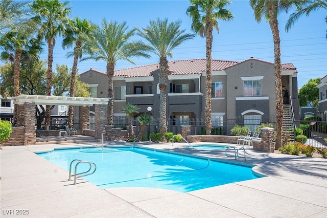 community pool featuring a patio area and fence