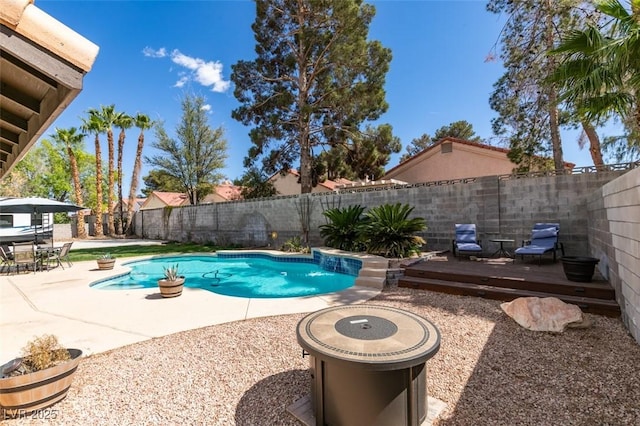 view of swimming pool featuring a fenced in pool, a fenced backyard, a patio area, and a wooden deck