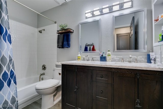 bathroom featuring double vanity, a sink, shower / tub combo, and toilet