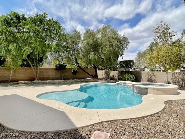 view of swimming pool featuring a patio, a pool with connected hot tub, and a fenced backyard