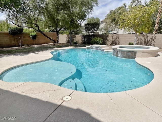 view of pool with a pool with connected hot tub, a fenced backyard, and a patio area