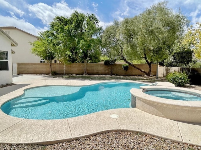 view of swimming pool with a fenced backyard, a patio, and a pool with connected hot tub