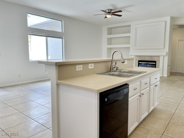 kitchen with a sink, light tile patterned floors, black dishwasher, and white cabinetry