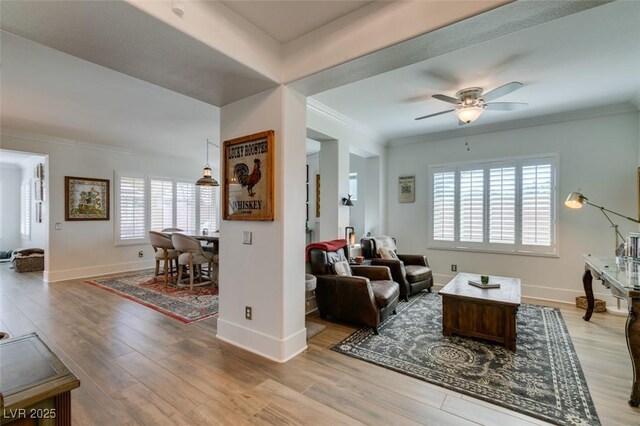 7349 Royal Melbourne Dr, Las Vegas, NV 89131 - living room with ornamental molding, a ceiling fan, and wood finished floors